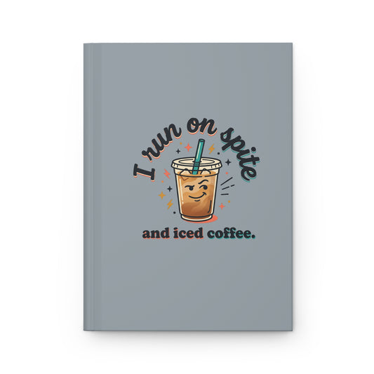 A gray hardcover notebook featuring a cute graphic of a smiling iced coffee cup with the text 'I run on spite and iced coffee.'